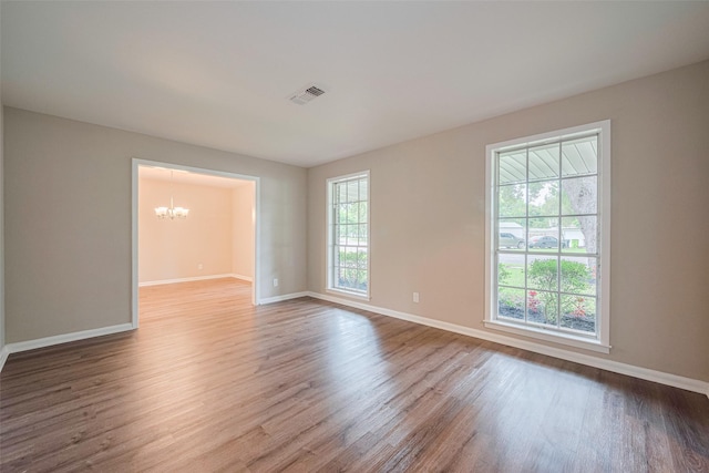 1316 Courtney St, Richmond, TX 77469 - spare room featuring a chandelier, wood finished floors, and baseboards