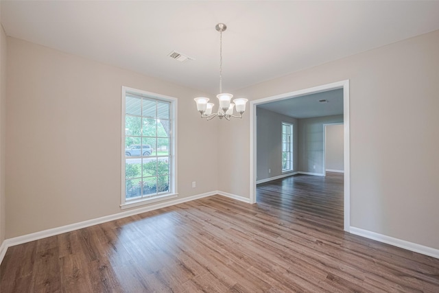 1316 Courtney St, Richmond, TX 77469 - spare room with a chandelier, plenty of natural light, and wood finished floors