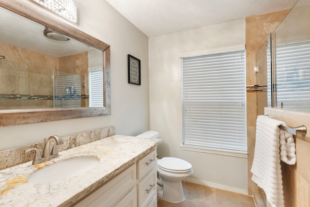 4 Hickory Oak Dr, Spring, TX 77381 - bathroom with tiled shower, vanity, toilet, baseboards, and a textured ceiling