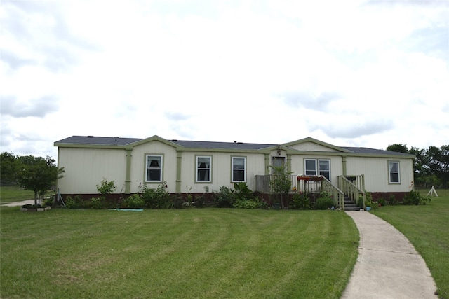 10912 Fm 523rd Rd, Angleton, TX 77515 - manufactured / mobile home featuring a wooden deck and a front yard
