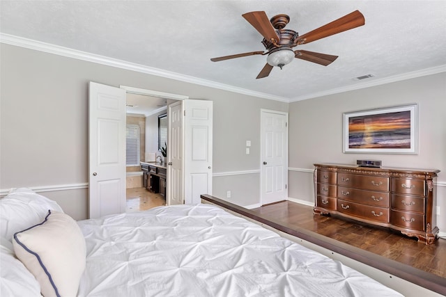3911 Misty Gardens Ct, Kingwood, TX 77339 - bedroom with wood finished floors, crown molding, a ceiling fan, ensuite bath, and baseboards