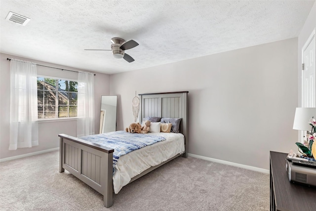 3911 Misty Gardens Ct, Kingwood, TX 77339 - bedroom with light carpet, baseboards, a textured ceiling, and ceiling fan