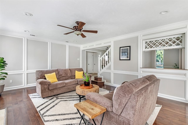 3911 Misty Gardens Ct, Kingwood, TX 77339 - living area featuring a decorative wall, dark wood-type flooring, crown molding, ceiling fan, and stairway
