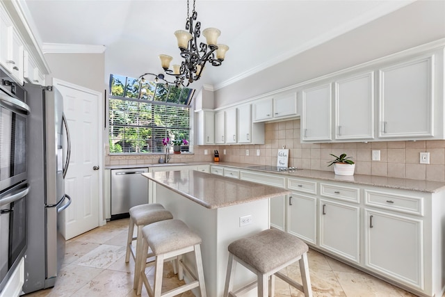 3911 Misty Gardens Ct, Kingwood, TX 77339 - kitchen with appliances with stainless steel finishes, a sink, decorative backsplash, white cabinetry, and ornamental molding