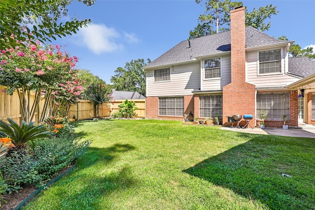 3911 Misty Gardens Ct, Kingwood, TX 77339 - rear view of house featuring a patio area, brick siding, a chimney, and a shingled roof