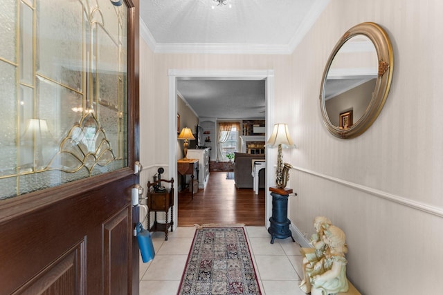 23826 Farm Hill Rd, Spring, TX 77373 - entryway featuring ornamental molding, a fireplace, and light tile patterned floors
