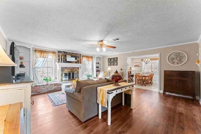 23826 Farm Hill Rd, Spring, TX 77373 - living room featuring a ceiling fan, crown molding, wood finished floors, a textured ceiling, and built in shelves