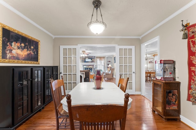 23826 Farm Hill Rd, Spring, TX 77373 - dining space featuring french doors, wood finished floors, crown molding, baseboards, and a ceiling fan