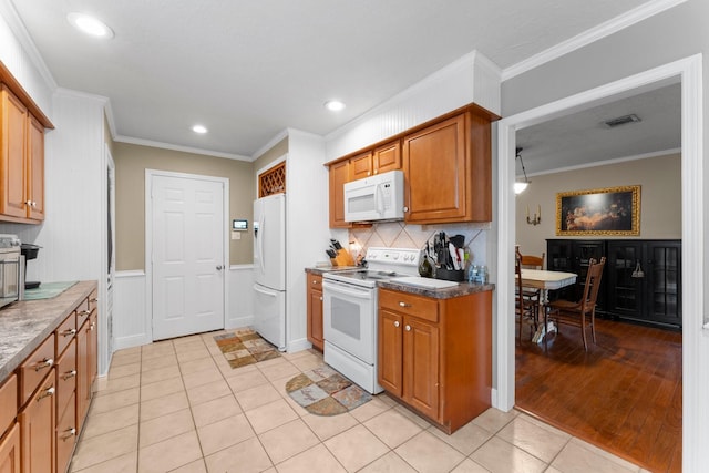 23826 Farm Hill Rd, Spring, TX 77373 - kitchen with white appliances, crown molding, light tile patterned floors, brown cabinets, and backsplash