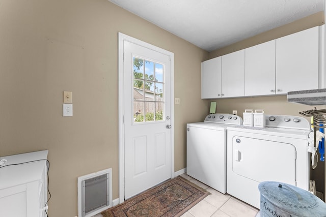 23826 Farm Hill Rd, Spring, TX 77373 - laundry room with cabinet space, separate washer and dryer, light tile patterned flooring, heating unit, and baseboards