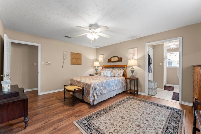 23826 Farm Hill Rd, Spring, TX 77373 - bedroom featuring wood finished floors, baseboards, a textured ceiling, and a ceiling fan