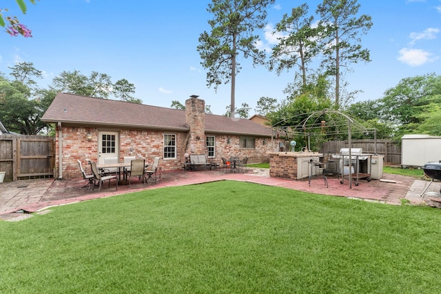 23826 Farm Hill Rd, Spring, TX 77373 - back of property with a patio, a chimney, brick siding, and a shingled roof