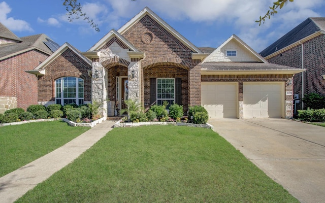 4419 Rolling Field Ln, Sugar Land, TX 77479 - view of front of home with a front lawn, an attached garage, brick siding, concrete driveway, and stone siding