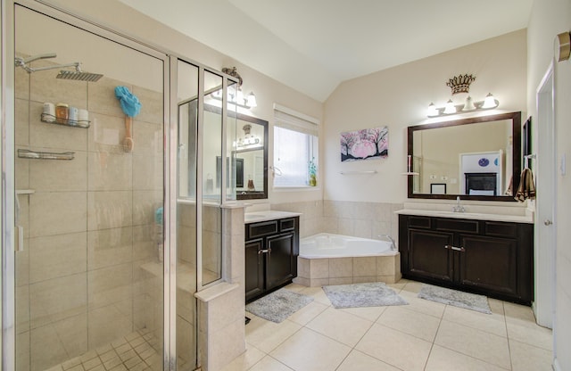 4419 Rolling Field Ln, Sugar Land, TX 77479 - bathroom featuring a shower stall, two vanities, a bath, vaulted ceiling, and tile patterned floors