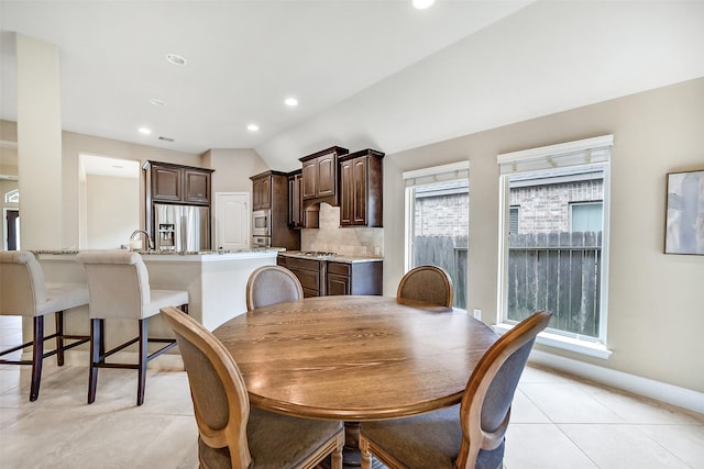 4011 Teramo Ln, Katy, TX 77493 - dining area featuring lofted ceiling, light tile patterned flooring, recessed lighting, and baseboards