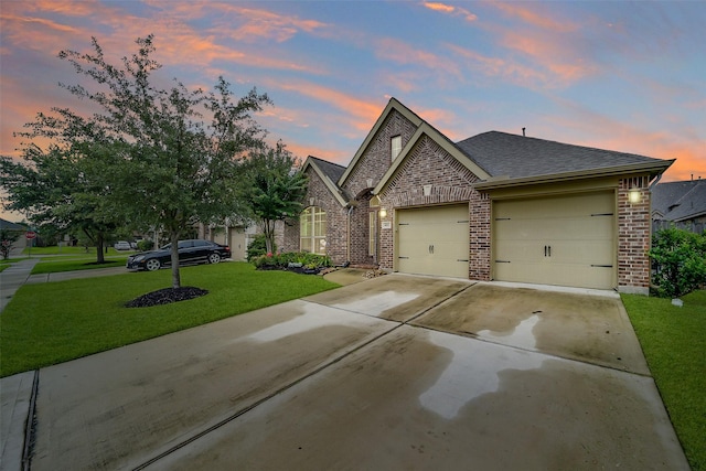 4011 Teramo Ln, Katy, TX 77493 - french country style house with brick siding, a garage, a front lawn, concrete driveway, and roof with shingles
