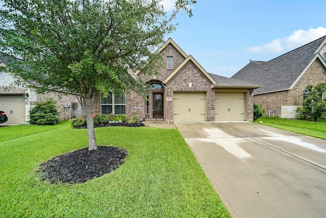 4011 Teramo Ln, Katy, TX 77493 - view of front of house with brick siding, an attached garage, a front yard, driveway, and roof with shingles