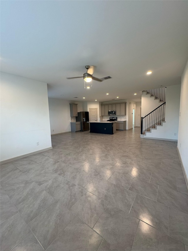 29506 Wilkerson Ln, Katy, TX 77494 - unfurnished living room featuring baseboards, stairs, ceiling fan, and recessed lighting