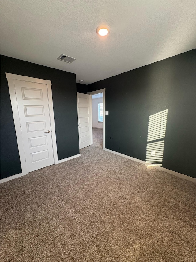 29506 Wilkerson Ln, Katy, TX 77494 - unfurnished bedroom with carpet floors, baseboards, and a textured ceiling
