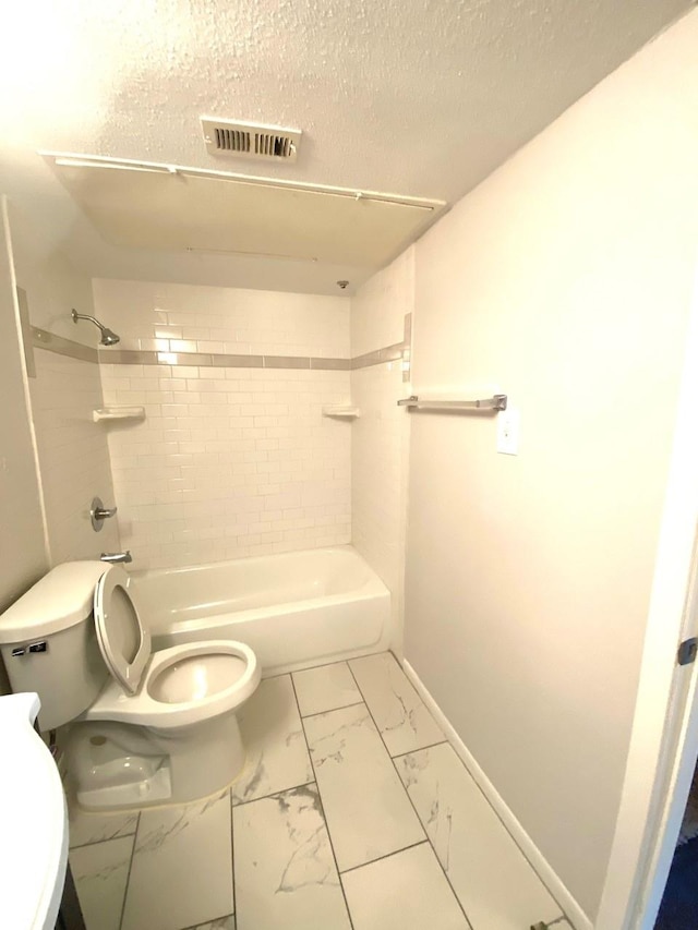9000 Bissonnet St Unit 707, Houston, TX 77074 - bathroom with toilet, shower / tub combination, marble look tiles, baseboards, and a textured ceiling