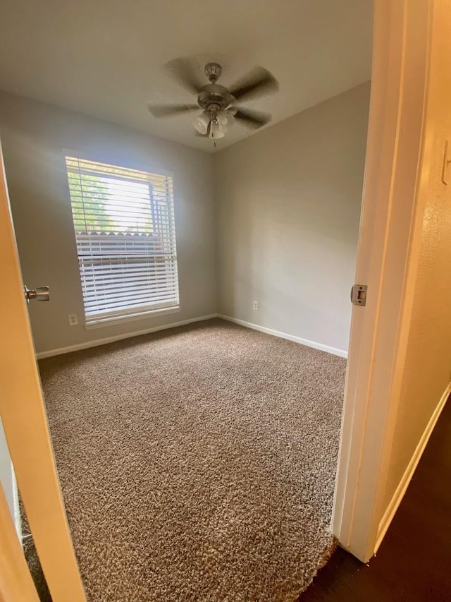9000 Bissonnet St Unit 707, Houston, TX 77074 - spare room with dark carpet, baseboards, and ceiling fan
