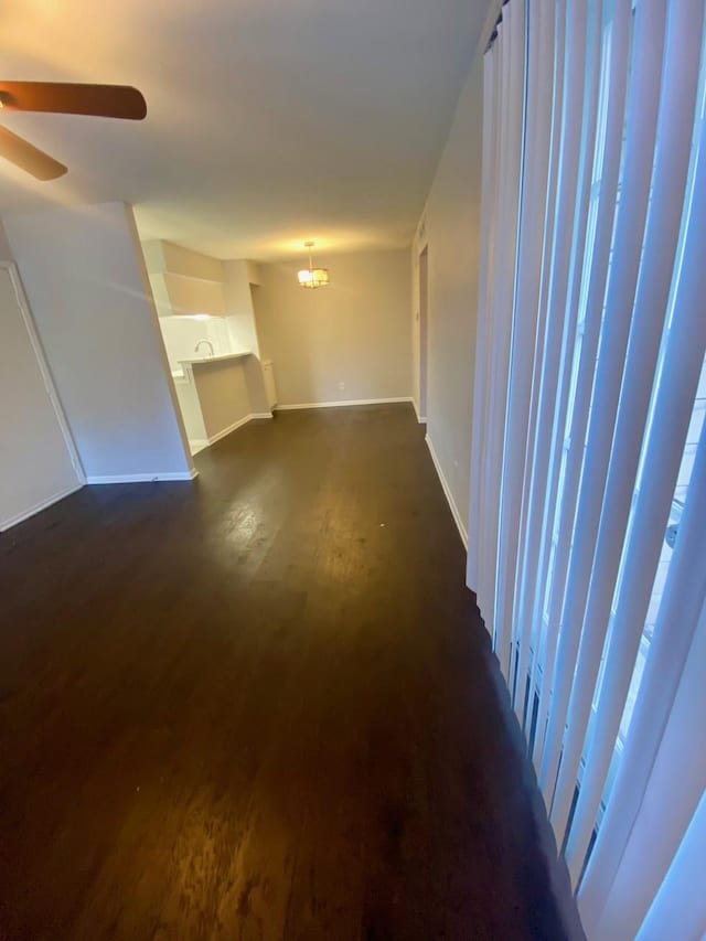 9000 Bissonnet St Unit 707, Houston, TX 77074 - unfurnished living room with ceiling fan, baseboards, and dark wood-style floors