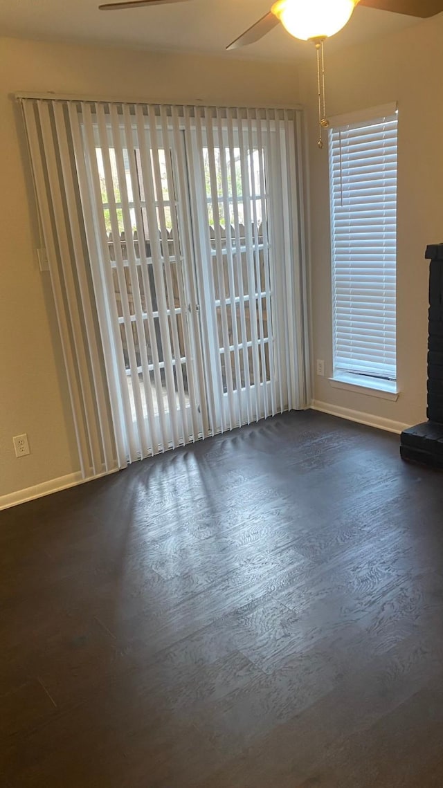 9000 Bissonnet St Unit 707, Houston, TX 77074 - unfurnished room featuring a ceiling fan, baseboards, plenty of natural light, and wood finished floors