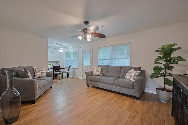 4210 Mona Lee Ln, Houston, TX 77080 - living area with light wood-style flooring, a ceiling fan, and baseboards