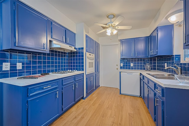 4210 Mona Lee Ln, Houston, TX 77080 - kitchen with white appliances, blue cabinetry, a sink, ceiling fan, and under cabinet range hood