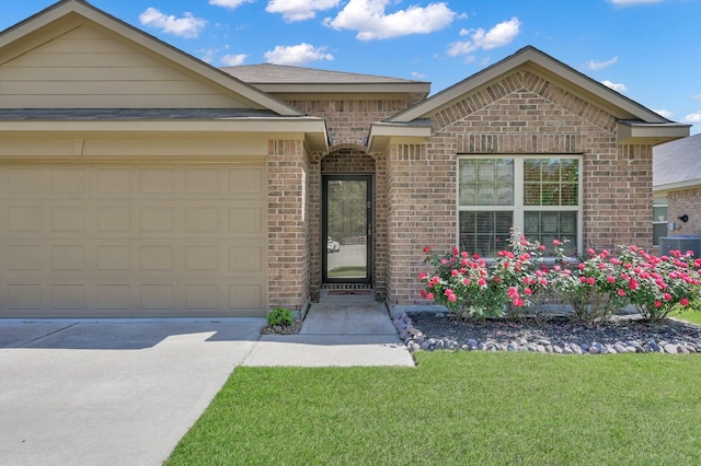 9923 Berlandier Ash Ln, Tomball, TX 77375 - ranch-style home featuring brick siding, driveway, a front yard, a garage, and cooling unit
