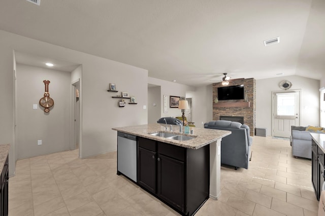 9923 Berlandier Ash Ln, Tomball, TX 77375 - kitchen featuring stainless steel dishwasher, a sink, ceiling fan, a stone fireplace, and open floor plan