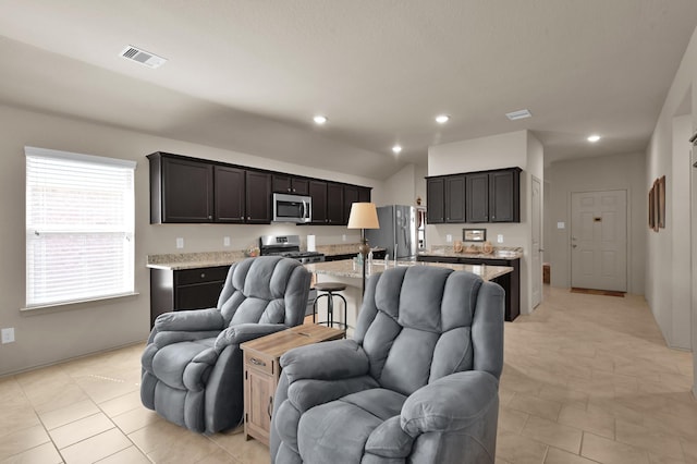 9923 Berlandier Ash Ln, Tomball, TX 77375 - living area featuring vaulted ceiling, light tile patterned floors, recessed lighting, and baseboards