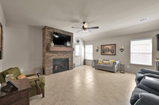 9923 Berlandier Ash Ln, Tomball, TX 77375 - living room featuring a ceiling fan, a stone fireplace, and lofted ceiling
