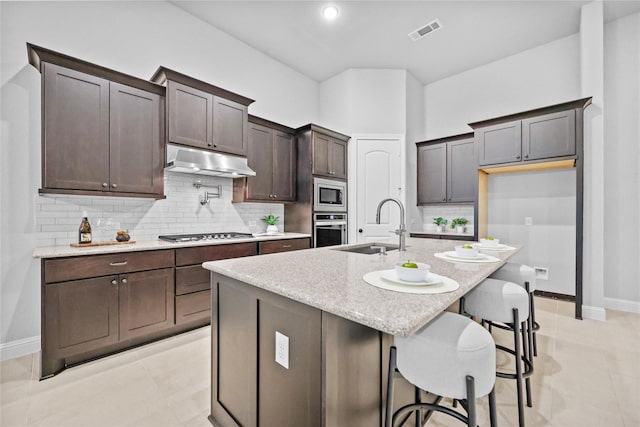 28227 Cedar Peak Dr, Spring, TX 77386 - kitchen with stainless steel appliances, under cabinet range hood, a sink, and baseboards