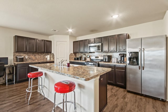 24402 Yellow Thyme Dr, Spring, TX 77373 - kitchen with appliances with stainless steel finishes, a sink, dark brown cabinets, dark wood-type flooring, and recessed lighting