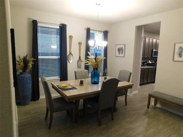 14827 Fairy Tern Ln, Houston, TX 77049 - dining space with wood finished floors, a chandelier, and baseboards
