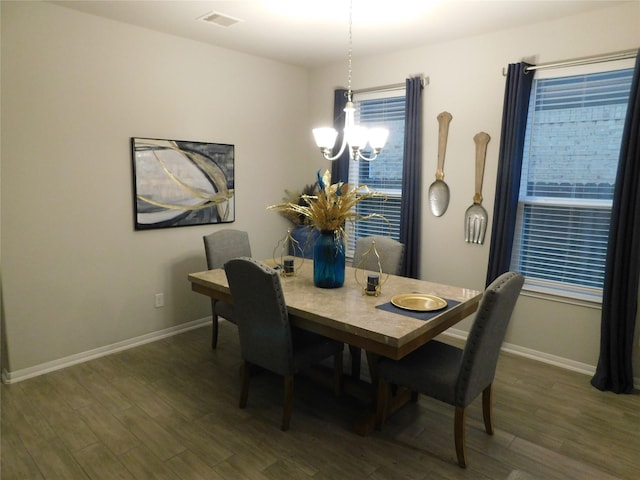14827 Fairy Tern Ln, Houston, TX 77049 - dining room featuring baseboards, dark wood finished floors, and a chandelier