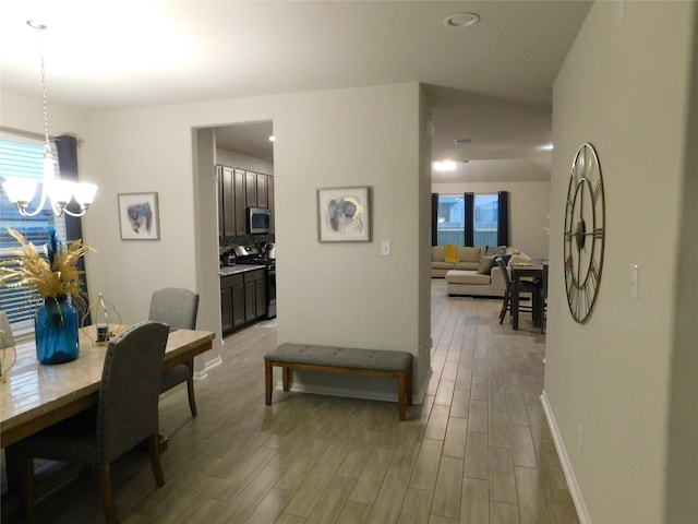 14827 Fairy Tern Ln, Houston, TX 77049 - dining space featuring light wood-style flooring, a chandelier, baseboards, and recessed lighting