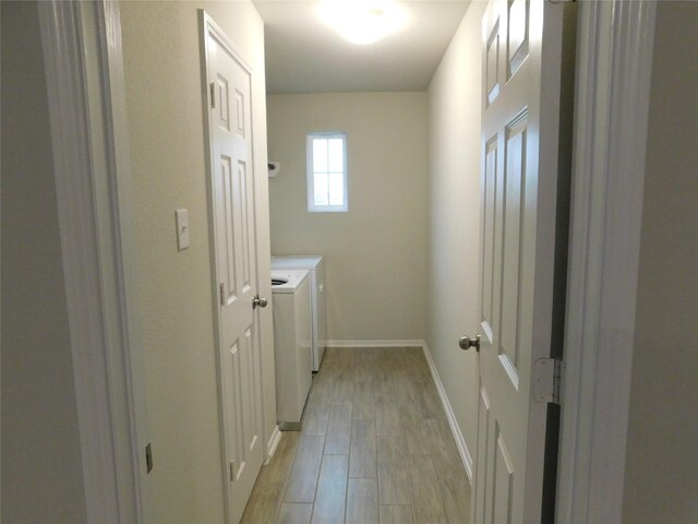 14827 Fairy Tern Ln, Houston, TX 77049 - laundry area with separate washer and dryer, light wood-style floors, and baseboards