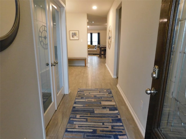 14827 Fairy Tern Ln, Houston, TX 77049 - hall with wood finished floors, baseboards, and french doors