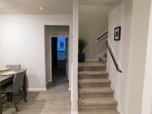 14827 Fairy Tern Ln, Houston, TX 77049 - stairs featuring baseboards and wood finished floors
