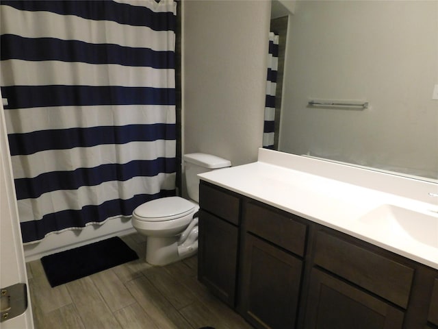 14827 Fairy Tern Ln, Houston, TX 77049 - bathroom with toilet, vanity, a shower with curtain, and wood finished floors