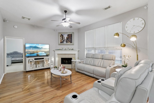 5023 Rocky Manor Ln, Katy, TX 77449 - living room with ceiling fan, wood finished floors, and a tile fireplace