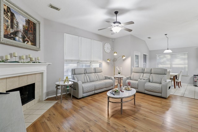 5023 Rocky Manor Ln, Katy, TX 77449 - living area featuring ceiling fan, vaulted ceiling, hardwood / wood-style floors, a fireplace, and baseboards