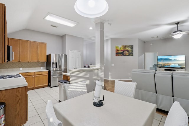 5023 Rocky Manor Ln, Katy, TX 77449 - dining space featuring light tile patterned floors, lofted ceiling, ceiling fan, and decorative columns