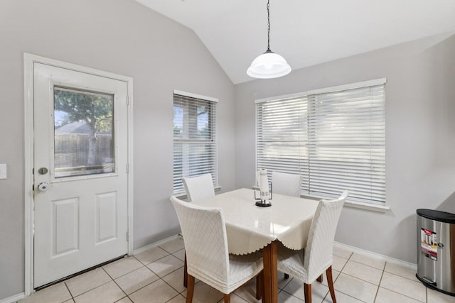 5023 Rocky Manor Ln, Katy, TX 77449 - dining room featuring light tile patterned flooring, vaulted ceiling, and baseboards