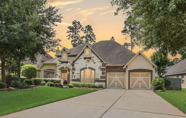 266 Overland Trce, Montgomery, TX 77316 - french country inspired facade featuring driveway, a chimney, a yard, and stone siding