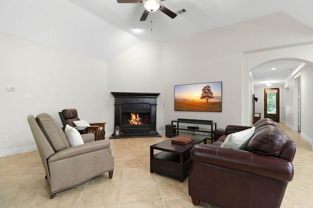 266 Overland Trce, Montgomery, TX 77316 - living area featuring arched walkways, a ceiling fan, light tile patterned floors, a warm lit fireplace, and baseboards