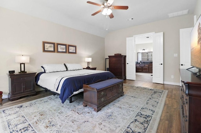 266 Overland Trce, Montgomery, TX 77316 - bedroom featuring wood finished floors, ensuite bath, baseboards, ceiling fan, and vaulted ceiling