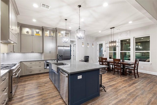 19817 Whispering Creek Trl, Magnolia, TX 77355 - kitchen featuring stainless steel appliances, recessed lighting, a sink, decorative backsplash, and dark wood finished floors